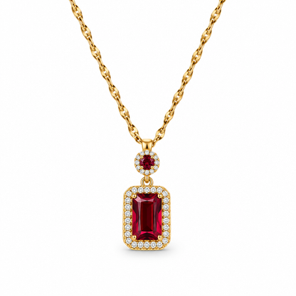 Złoty naszyjnik z prostokątną czerwoną cyrkonią na białym tle